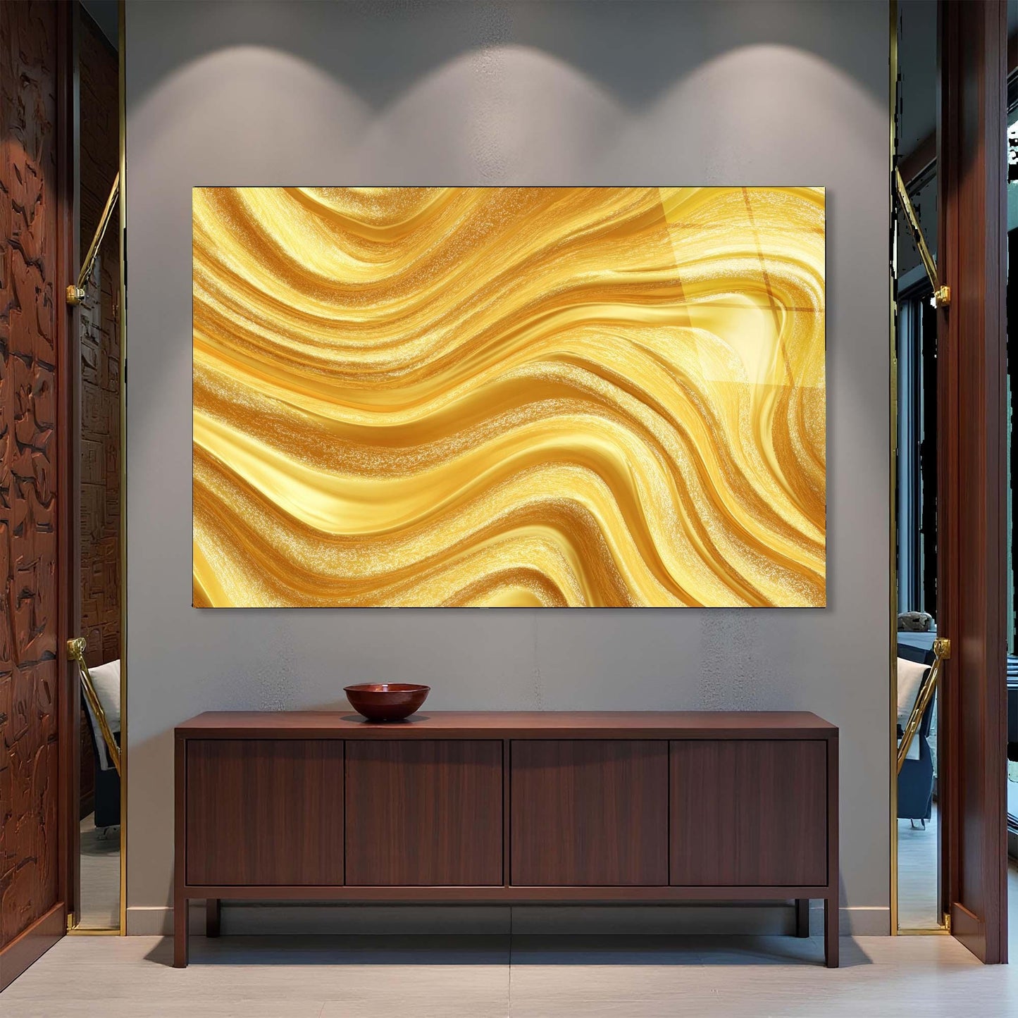 Gold abstract painting on a wall above a wooden cabinet