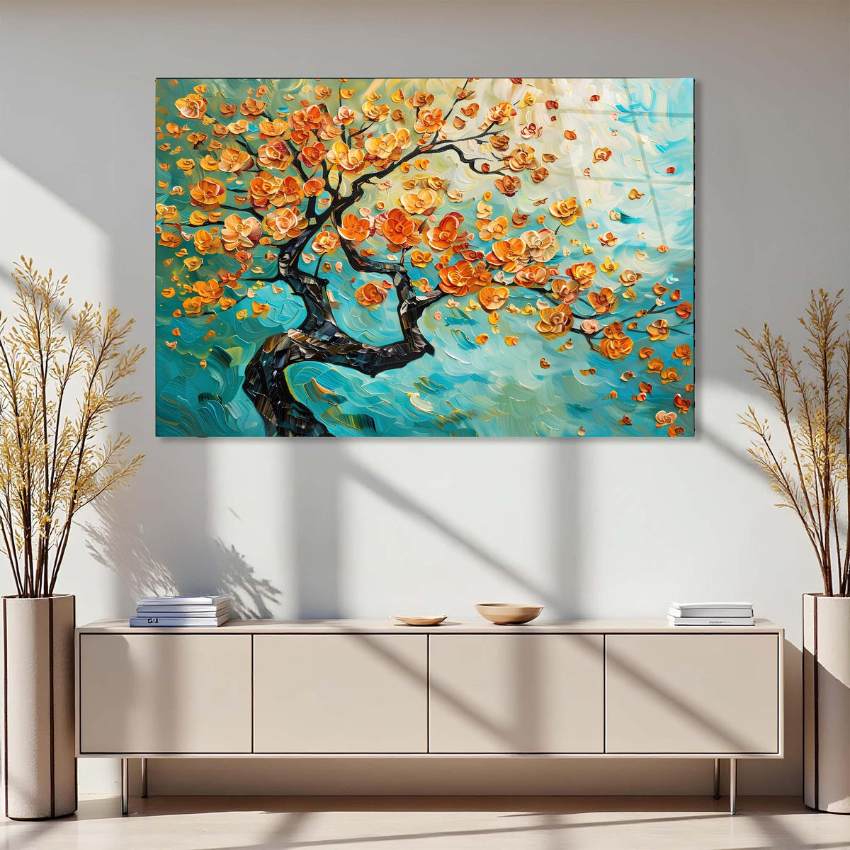 Colorful abstract painting of a tree with orange flowers on a wall above a light-colored cabinet.