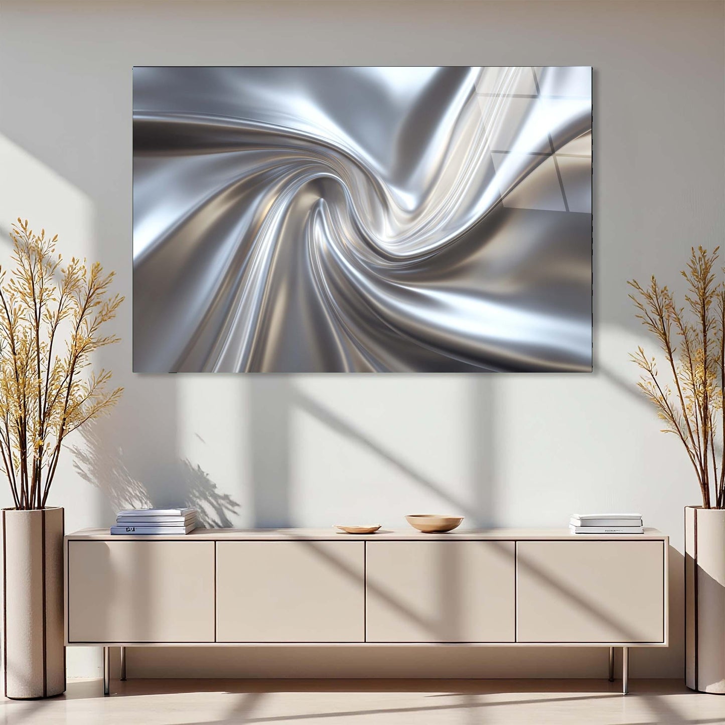 Abstract silver spiral artwork on a wall above a light-colored cabinet with decorative plants.