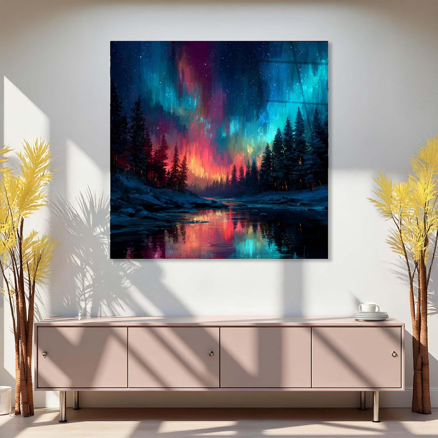 Framed artwork of a colorful Northern Lights over a forest displayed on a wall above a piece of furniture.