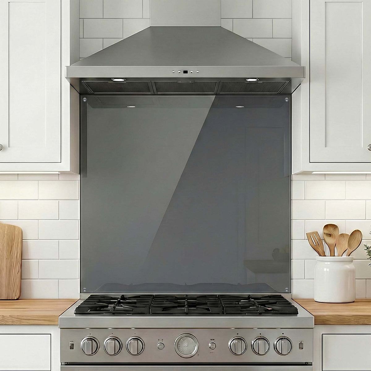 Stainless steel range with glass splashback in a kitchen setting
