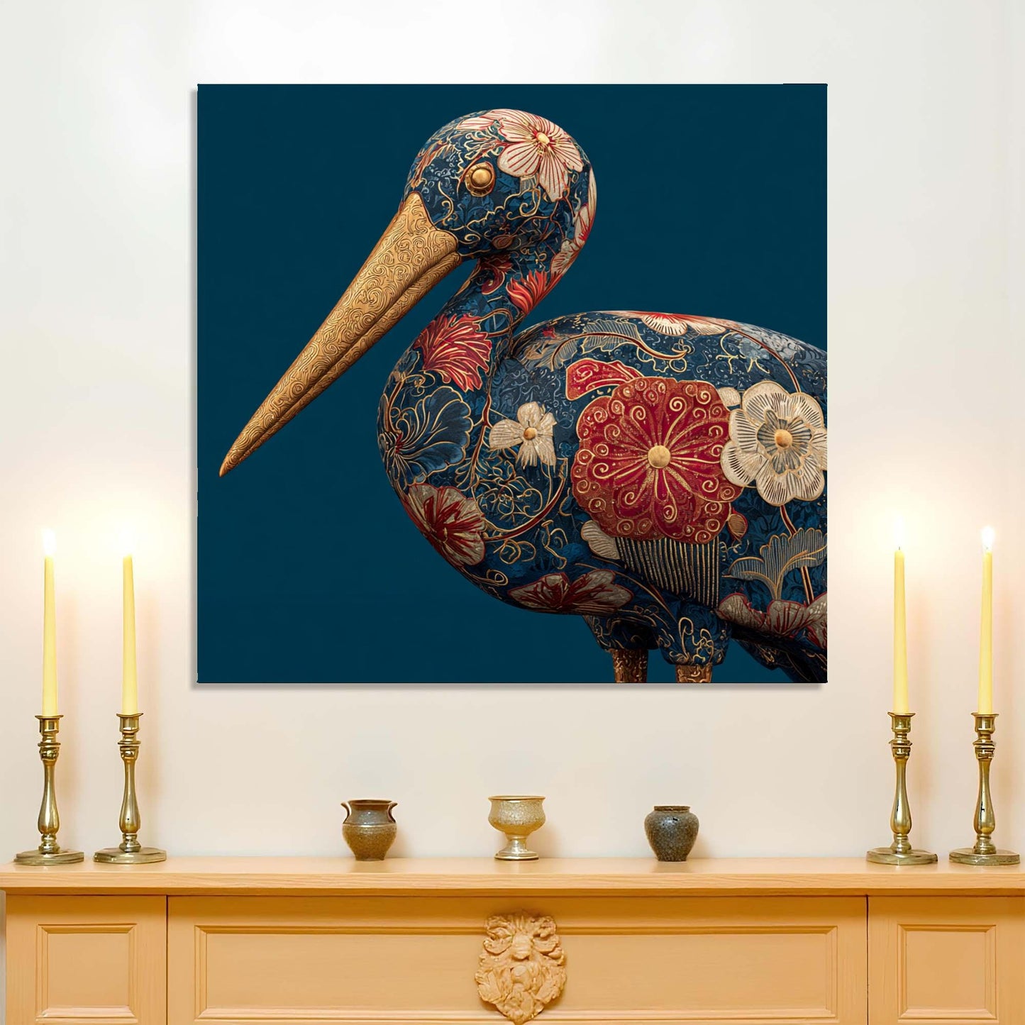 Decorative painting of a stylized pelican on a wall above a wooden cabinet with candles and small decorative items.