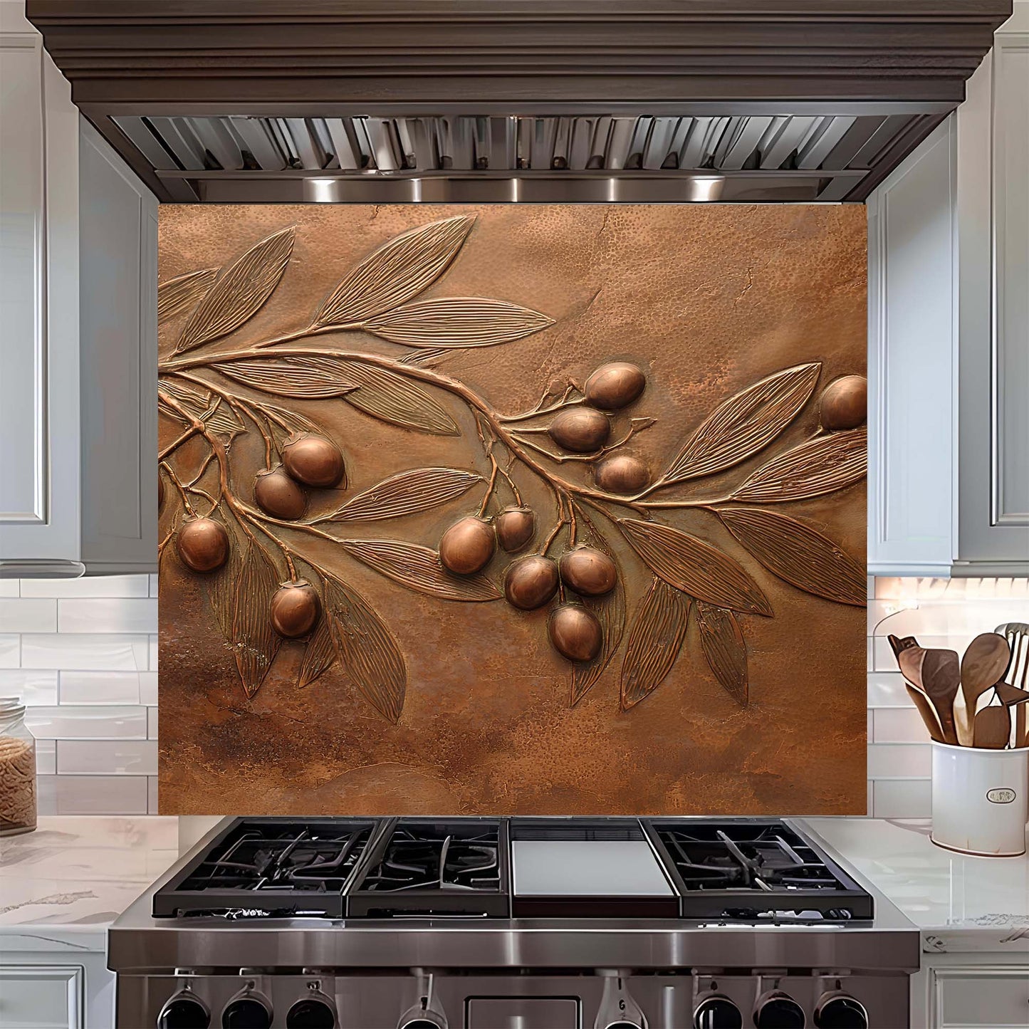 Decorative copper look glass backsplash with olive branch design above a stove in a kitchen.