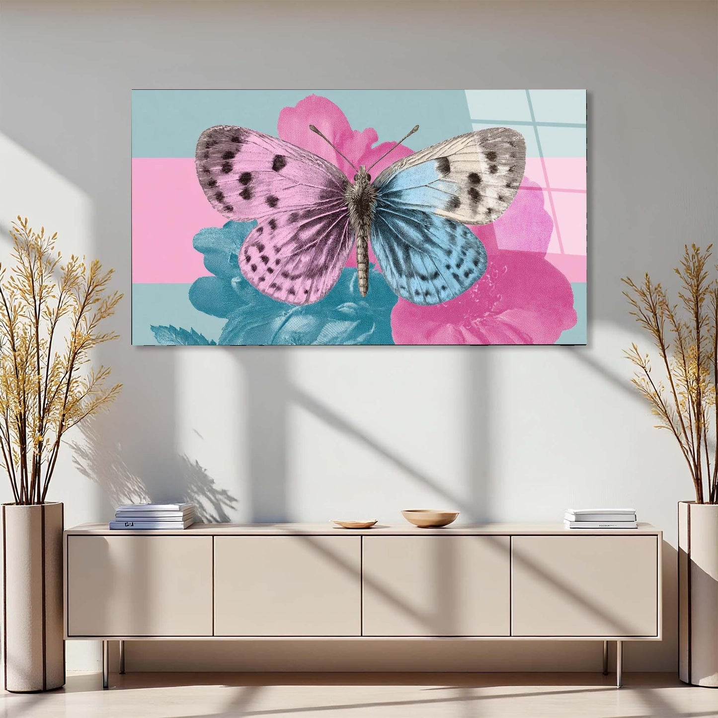 Butterfly on a pink flower painting above a beige console table with decorative plants.