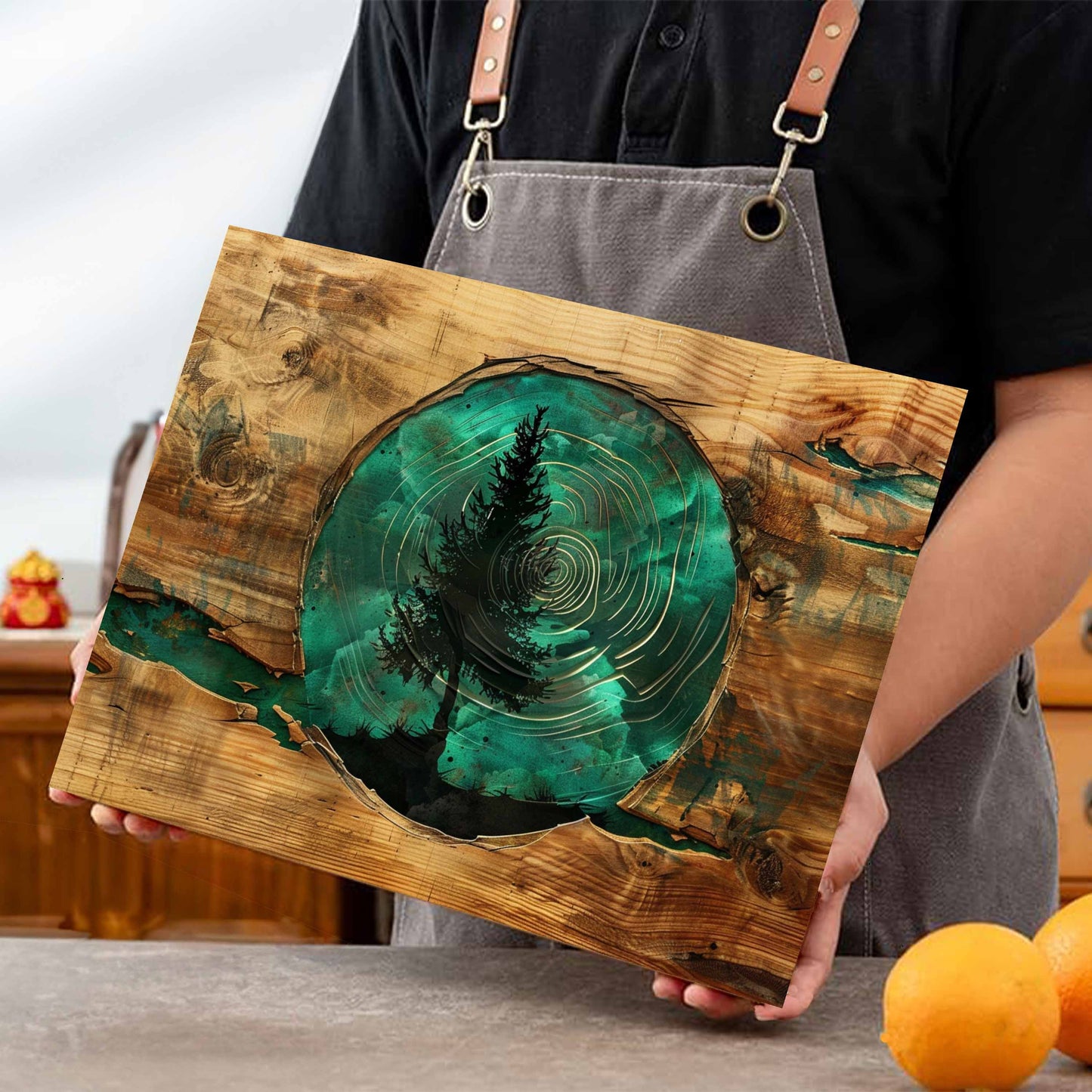 Person holding a glass kitchen cutting board with a green resin design