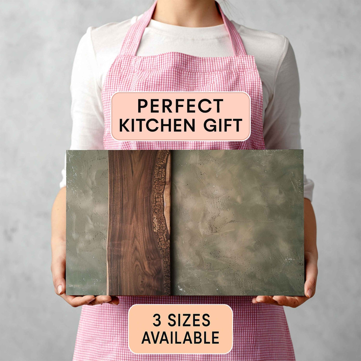 Person holding cutting board with a 'Perfect Kitchen Gift' and '3 Sizes Available' text on a gray background.
