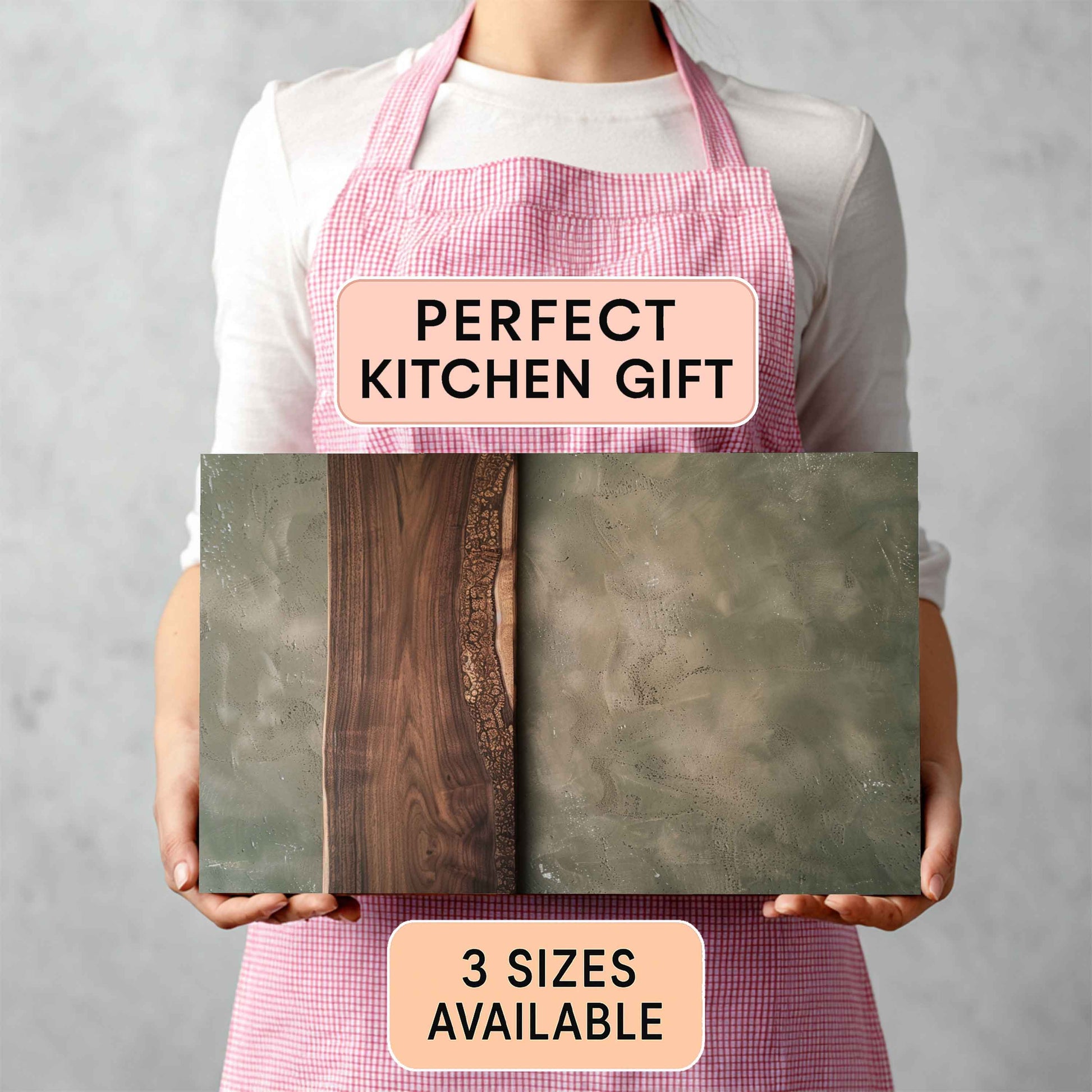 Person holding cutting board with a 'Perfect Kitchen Gift' and '3 Sizes Available' text on a gray background.