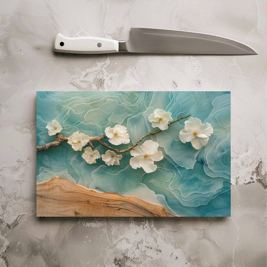 Chopping board with floral design on a gray surface with a knife above it