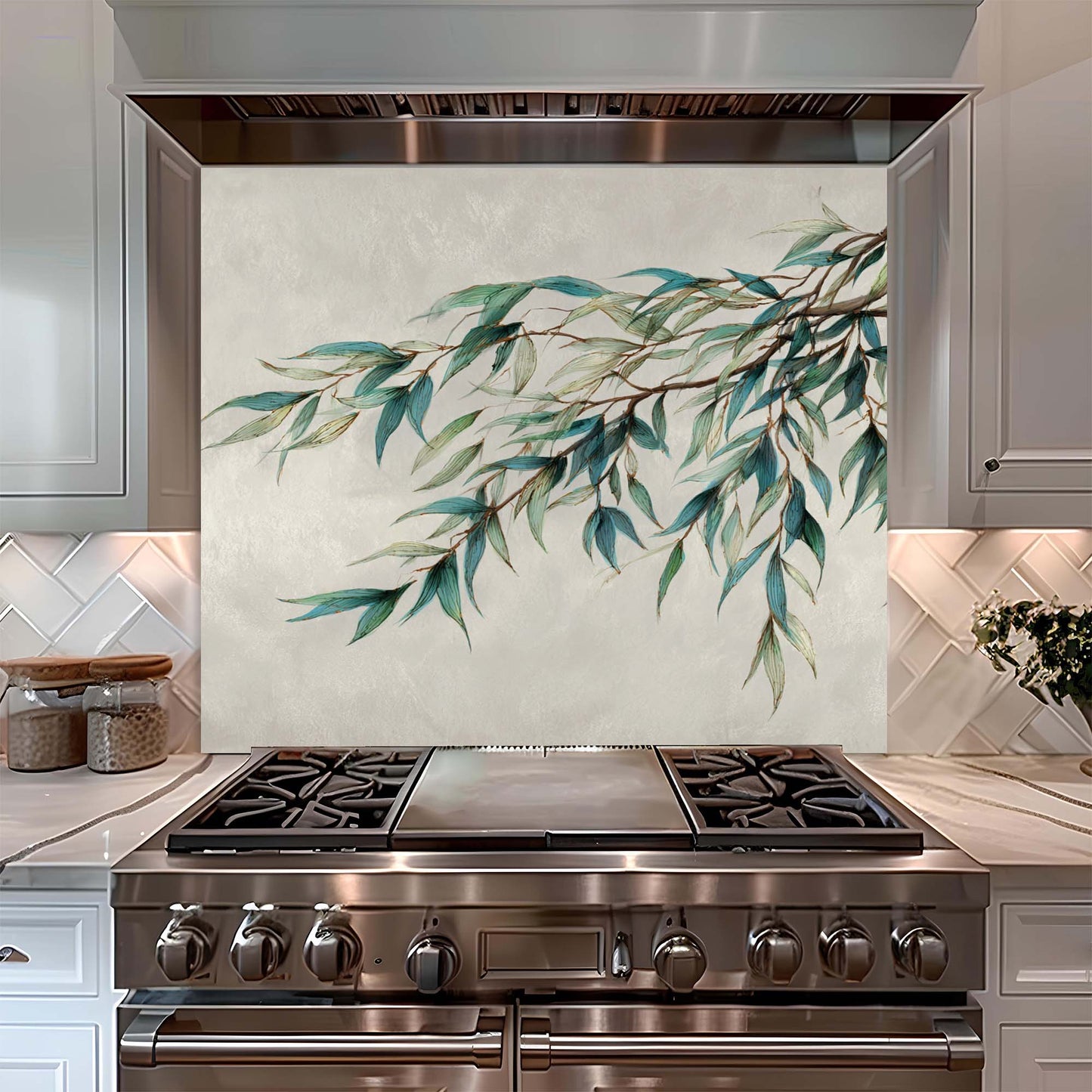 Stainless steel stove with decorative glass splashback featuring green leaves in a kitchen setting.