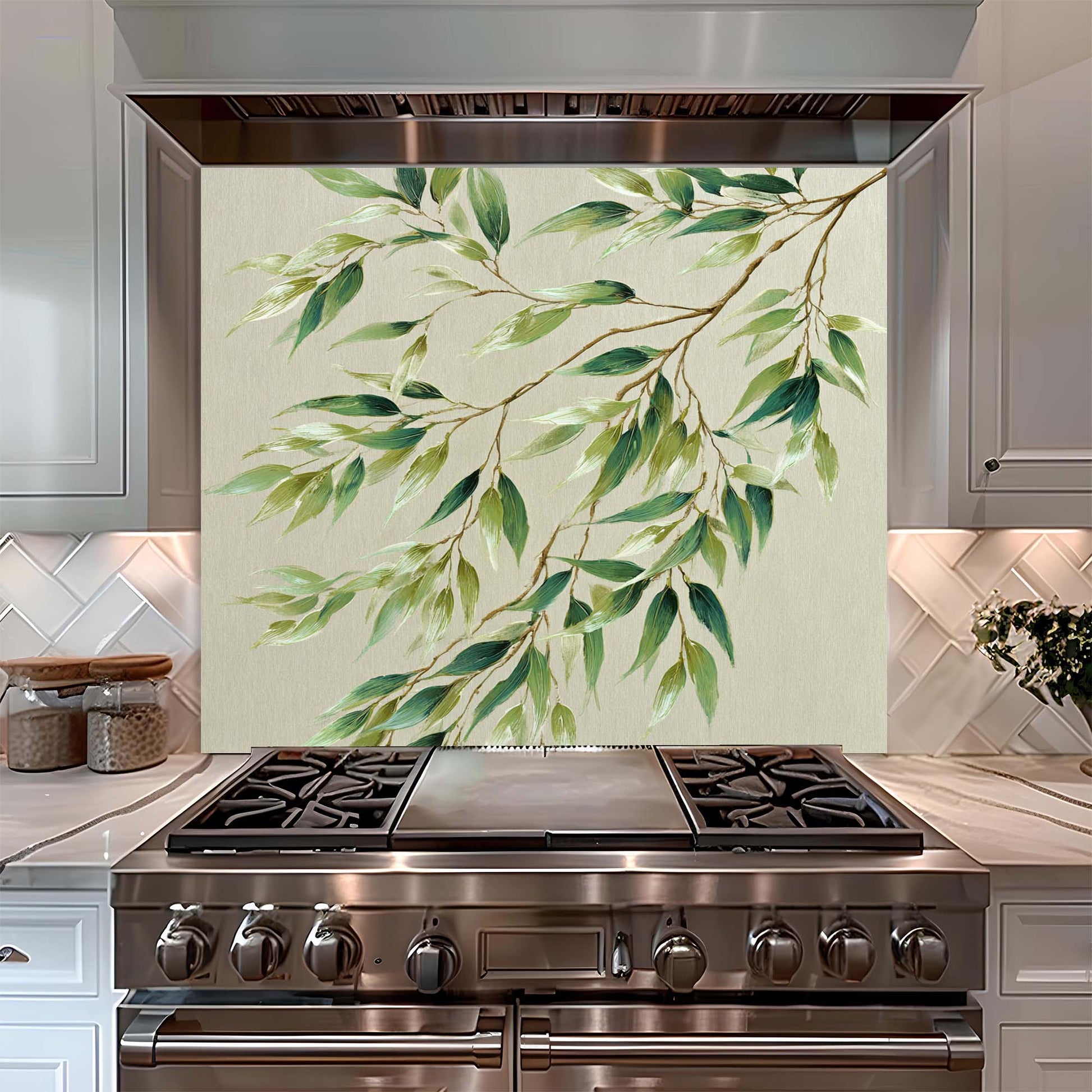 Stainless steel stove with decorative glass splashback featuring green leaves in a kitchen setting.