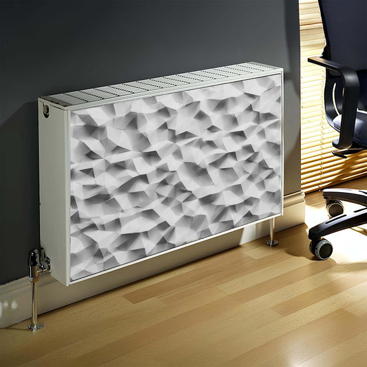 Decorative magnetic radiator cover with geometric pattern on a wall next to a chair.