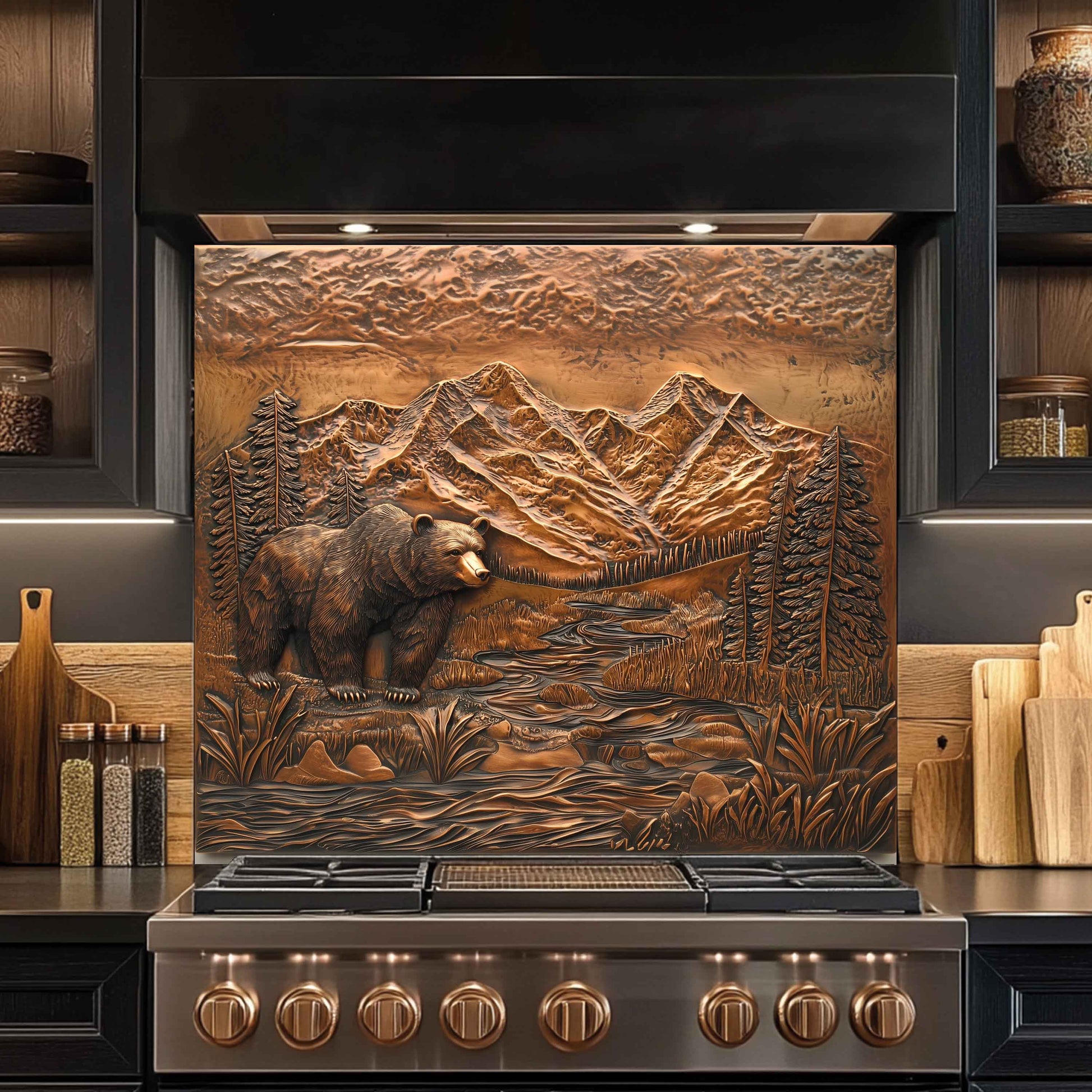 Stainless steel stove with decorative mountain and bear design on the front backsplash.