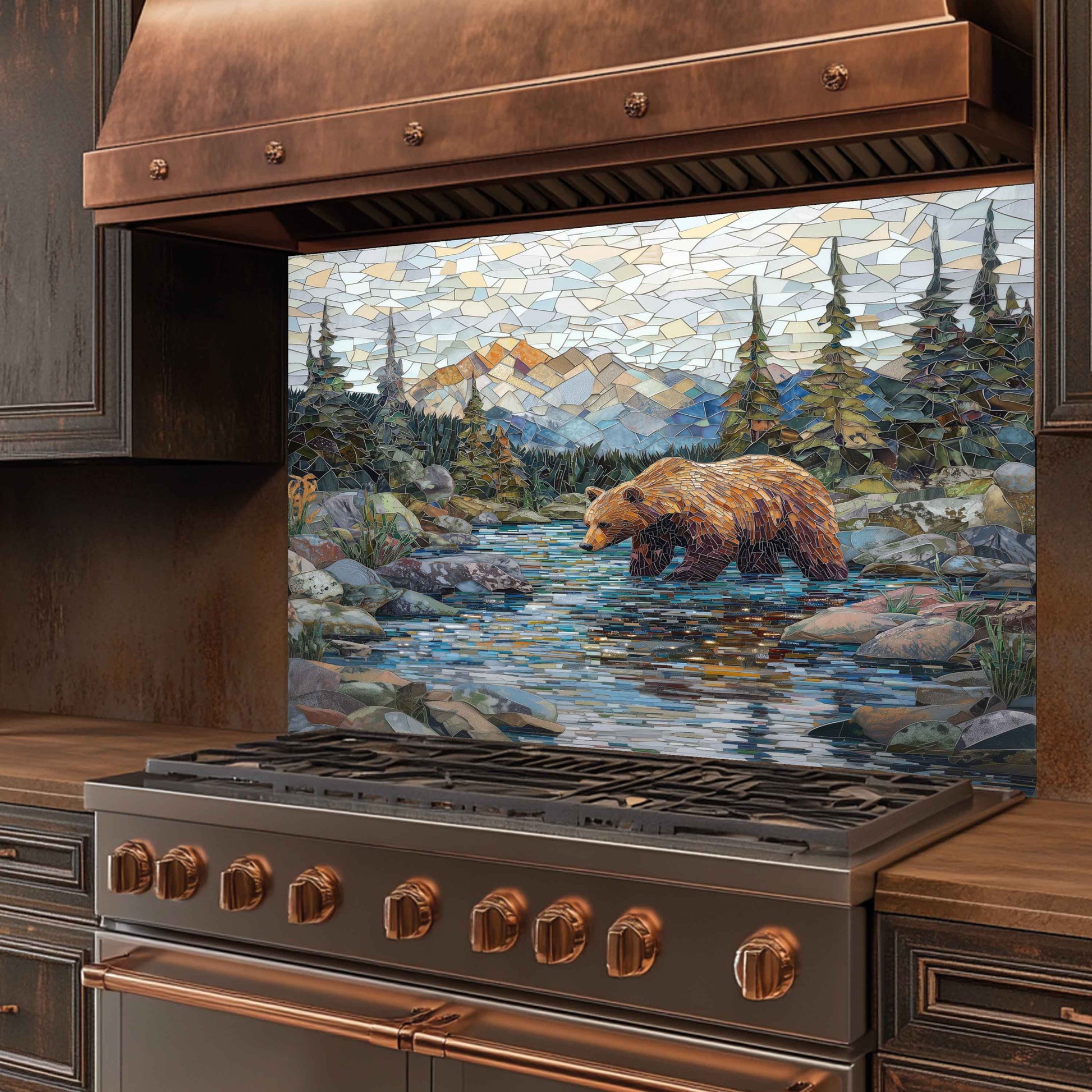 Stainless steel stove with copper accents and a decorative mosaic of a bear by a stream.