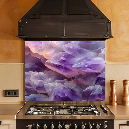 Stainless steel gas stove with a decorative purple glass splashback in a kitchen setting.