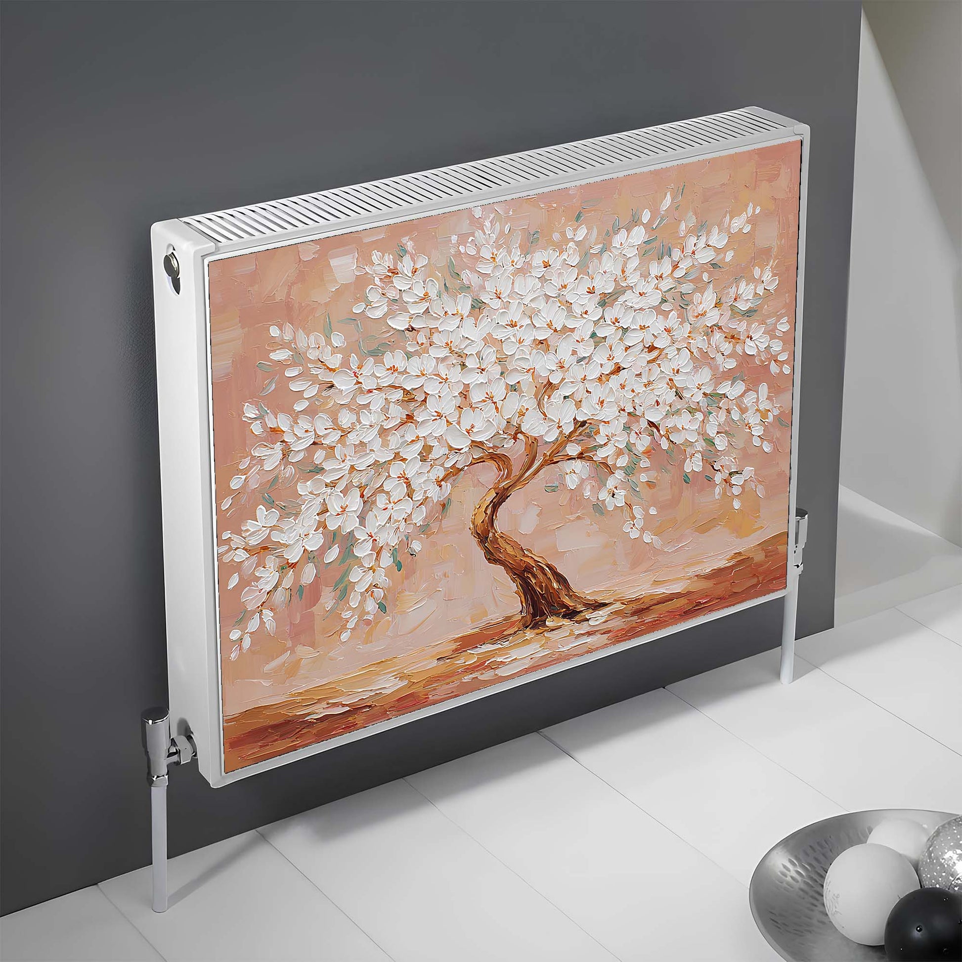 Decorative magnetic radiator cover with a painted tree design on a gray wall.