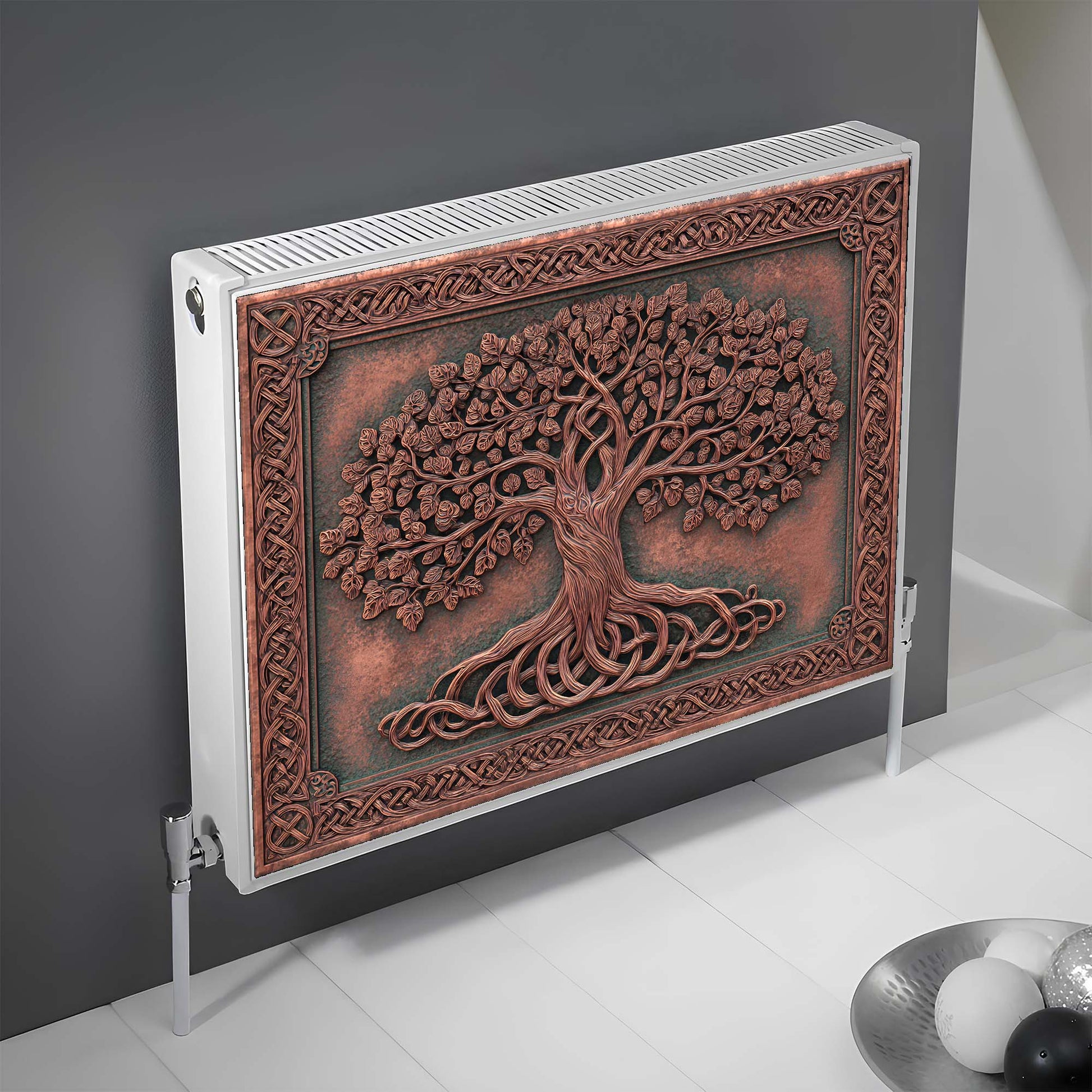 Decorative magnetic radiator cover with tree design on a gray wall.