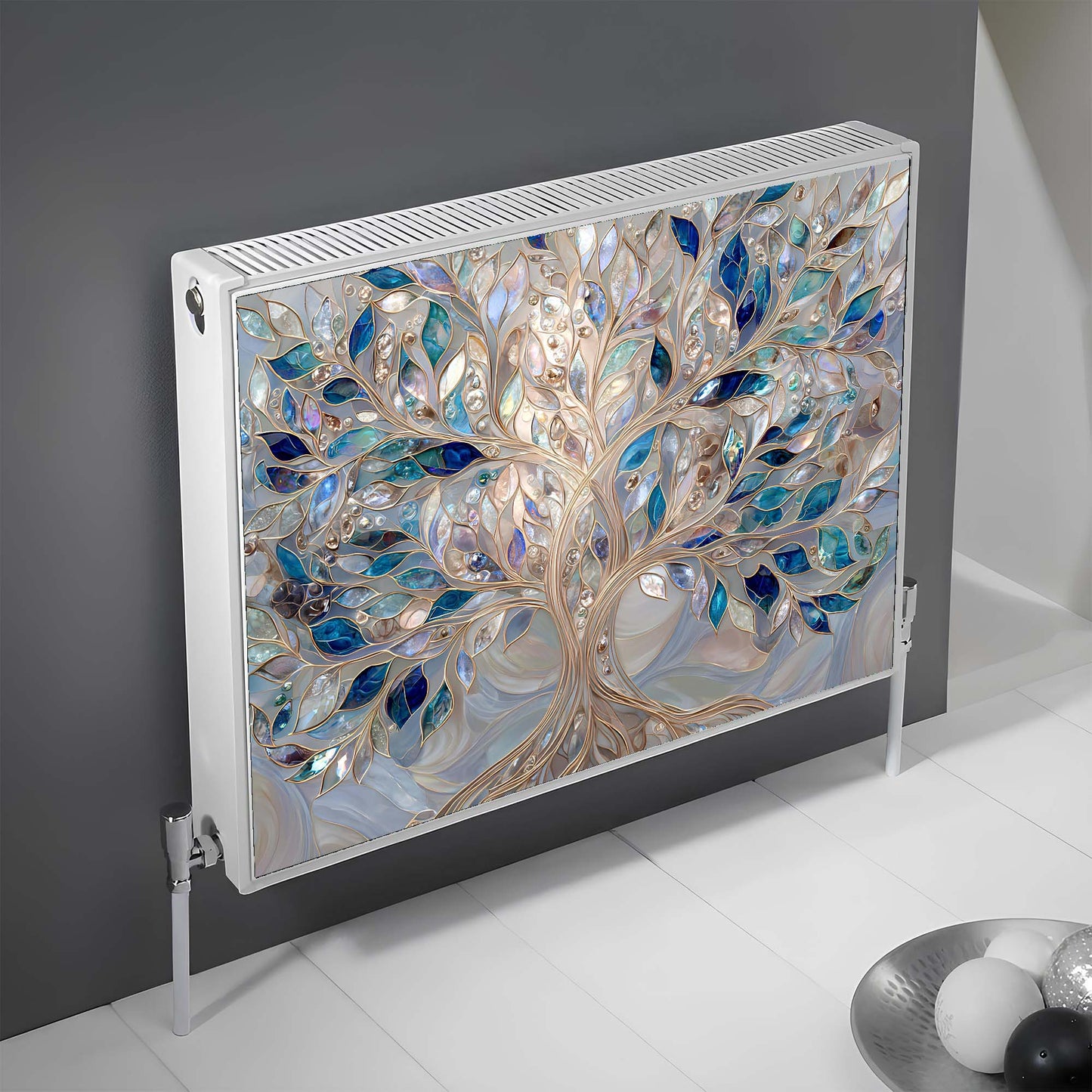 Decorative magnetic radiator cover with tree design on a gray wall.