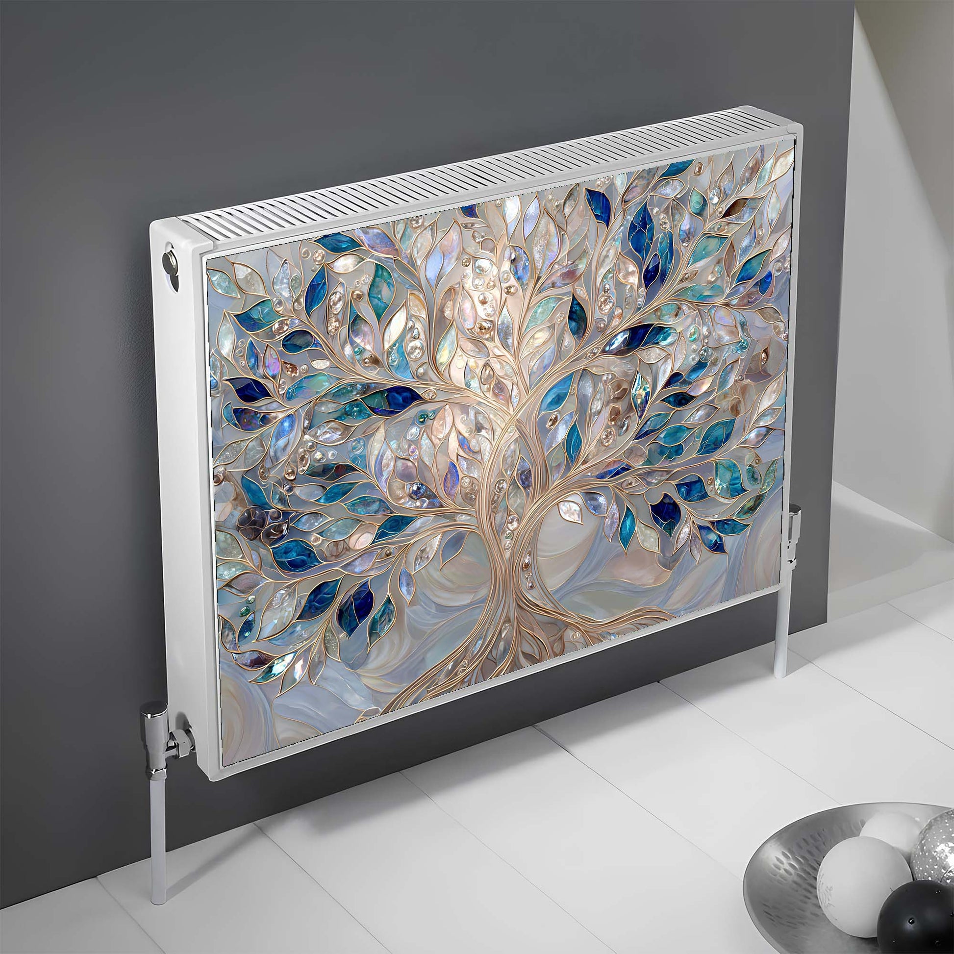 Decorative magnetic radiator cover with tree design on a gray wall.