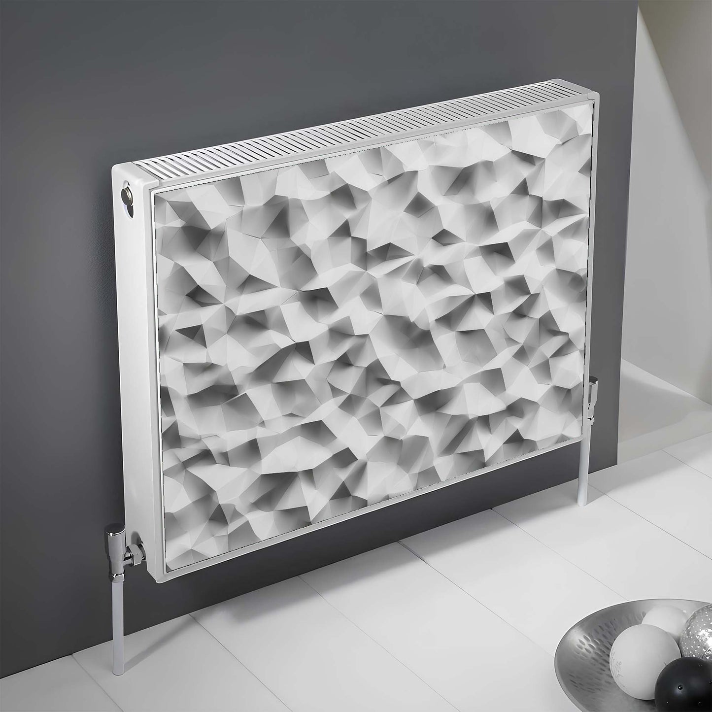 Decorative magnetic radiator cover with geometric pattern on a gray wall.