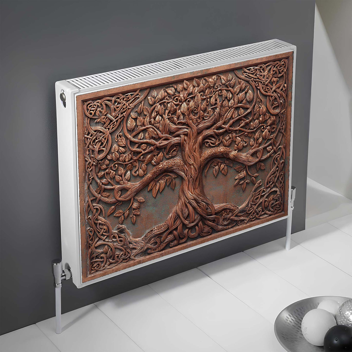 Decorative magnetic radiator cover with tree design on a gray wall.