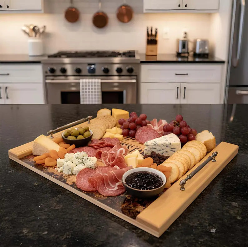 Charcuterie board with meats, cheeses, and fruits on a kitchen counter.