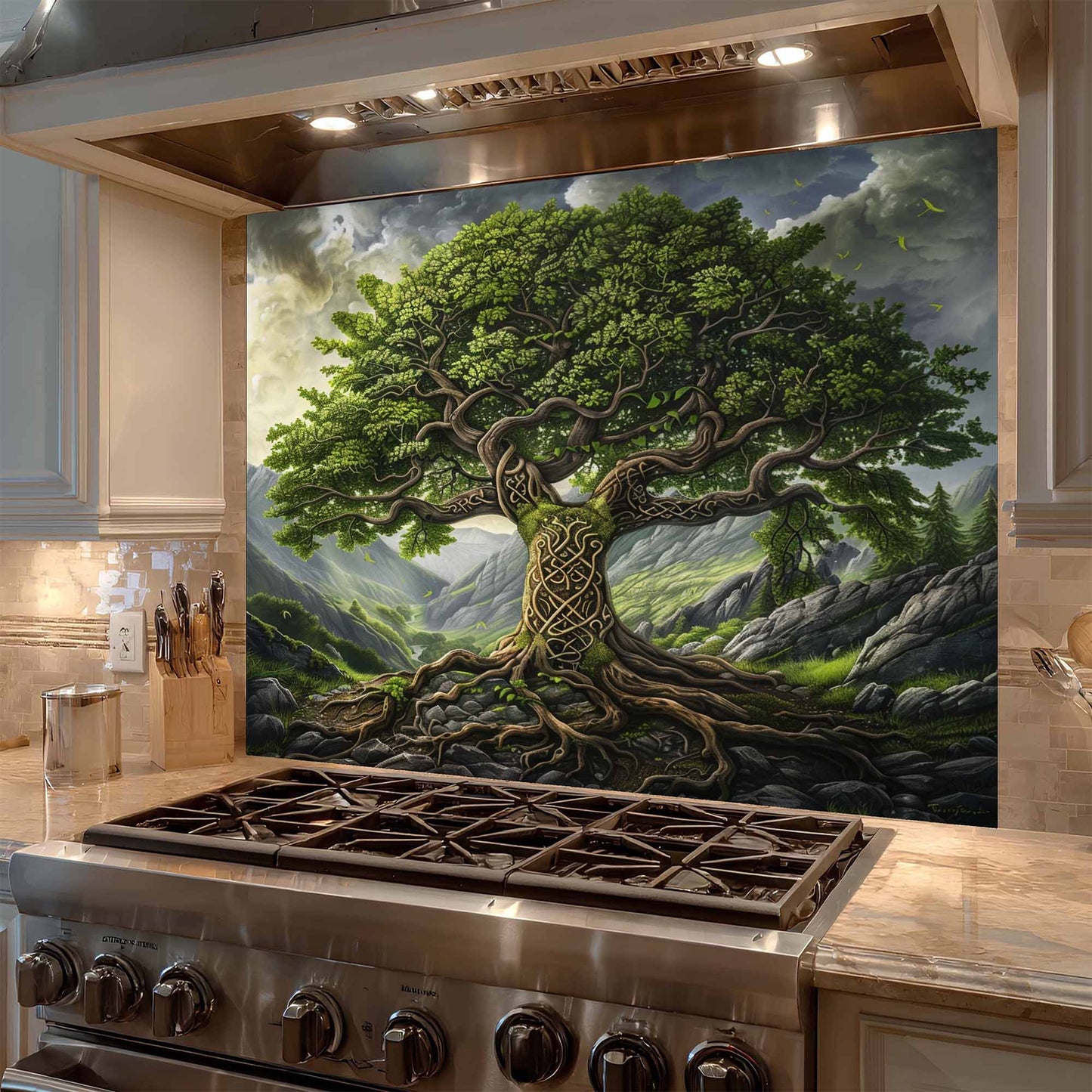 Stainless steel stove with a decorative wall panel featuring a tree and mountain landscape.