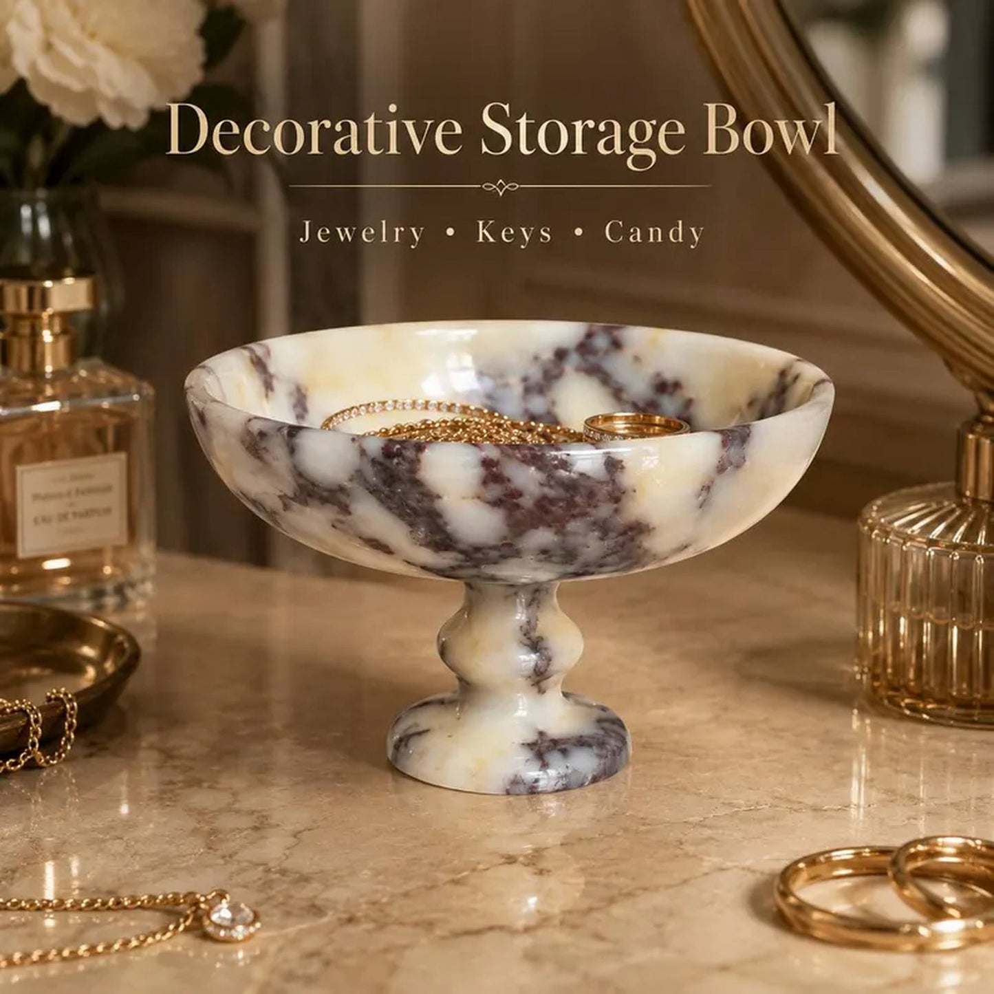 A decorative pedestal storage bowl made of cream and dark gray marbled stone, styled on a marble tabletop with jewelry and keys inside the bowl. Text overlay at the top reads 'Decorative Storage Bowl' with 'Jewelry • Keys • Candy' below.