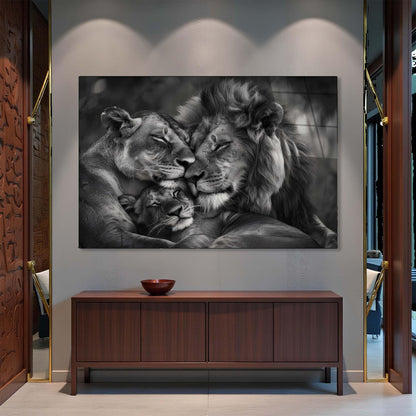 Black and white photo of a lion and cub on a wall above a wooden cabinet.