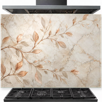 Copper branches design on a tempered glass kitchen backsplash panel installed behind a modern gas range stove.