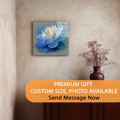 Decorative wall art of a blue flower on a beige wall with a vase below.