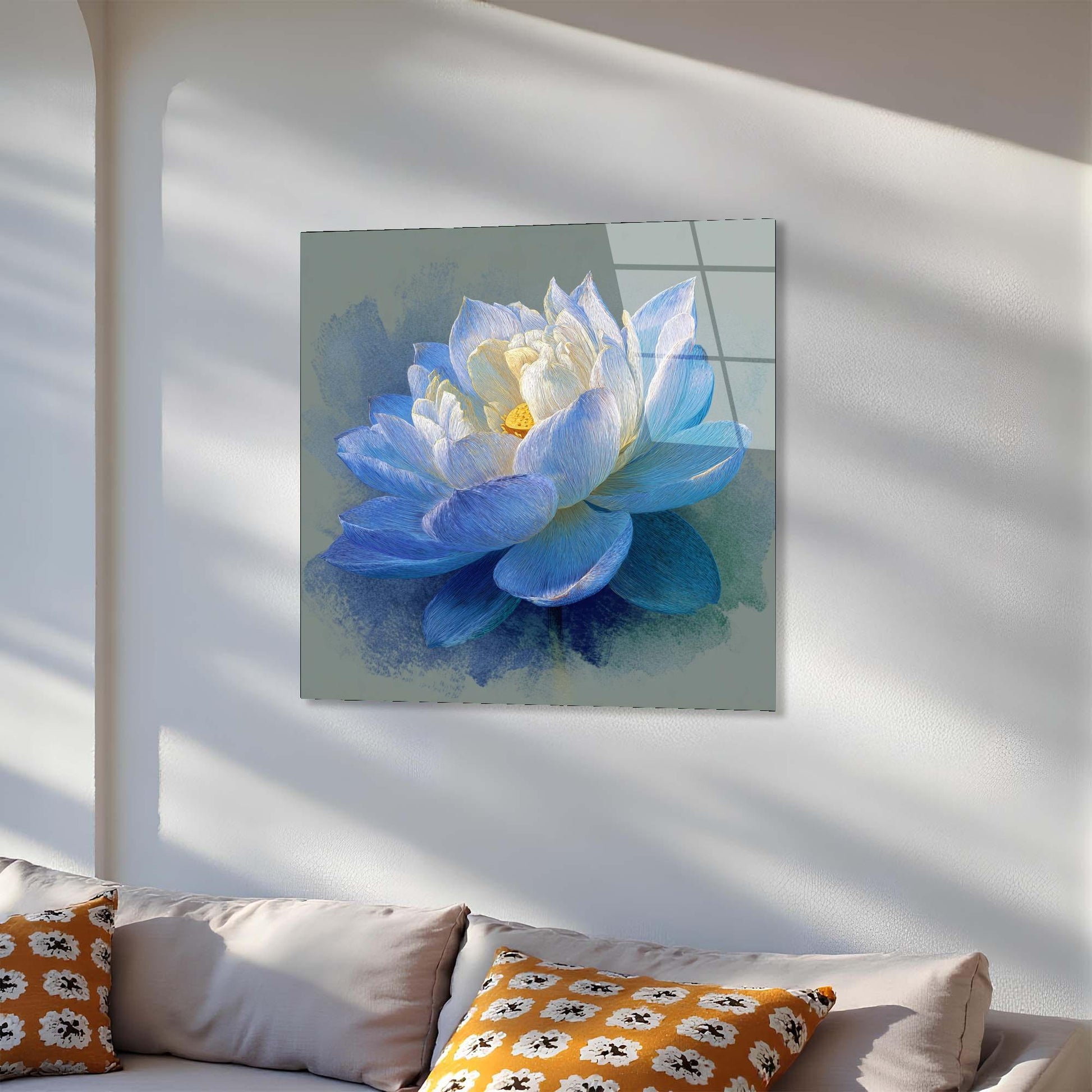 Blue flower painting on a wall above a sofa with patterned cushions.