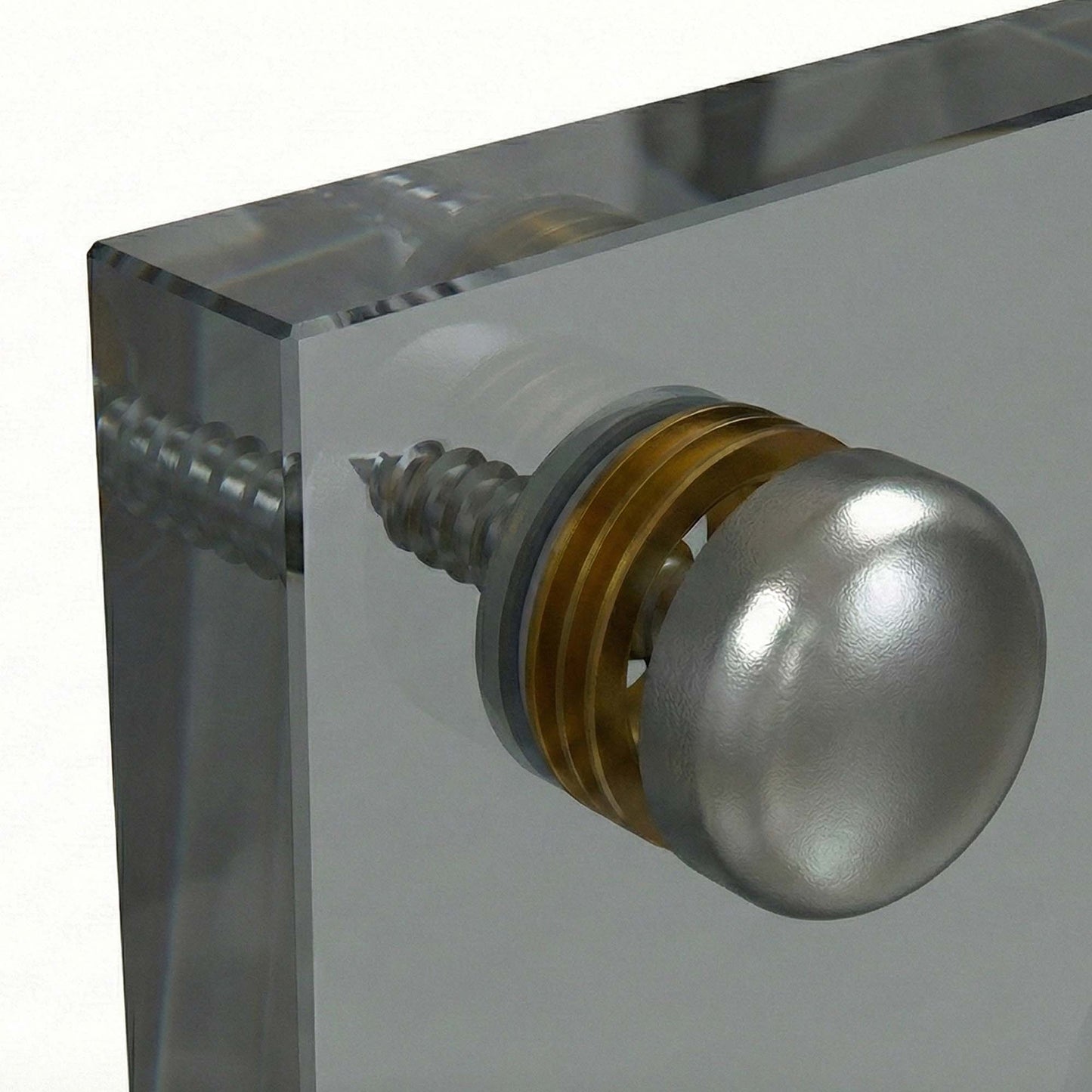 Metallic knob on a clear acrylic block with glass backsplash