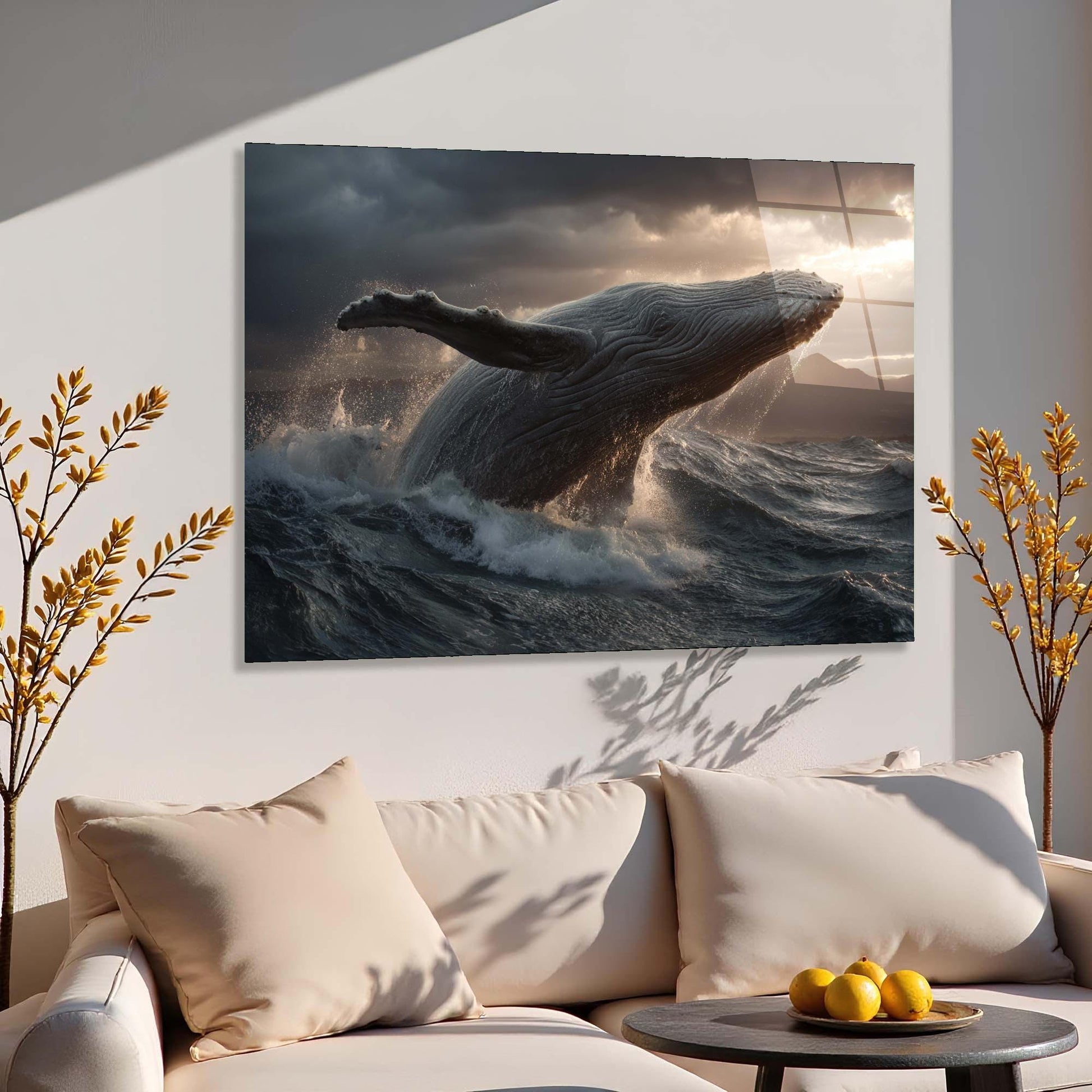 Sofa with decorative pillows and a painting of a whale leaping over water on the wall.