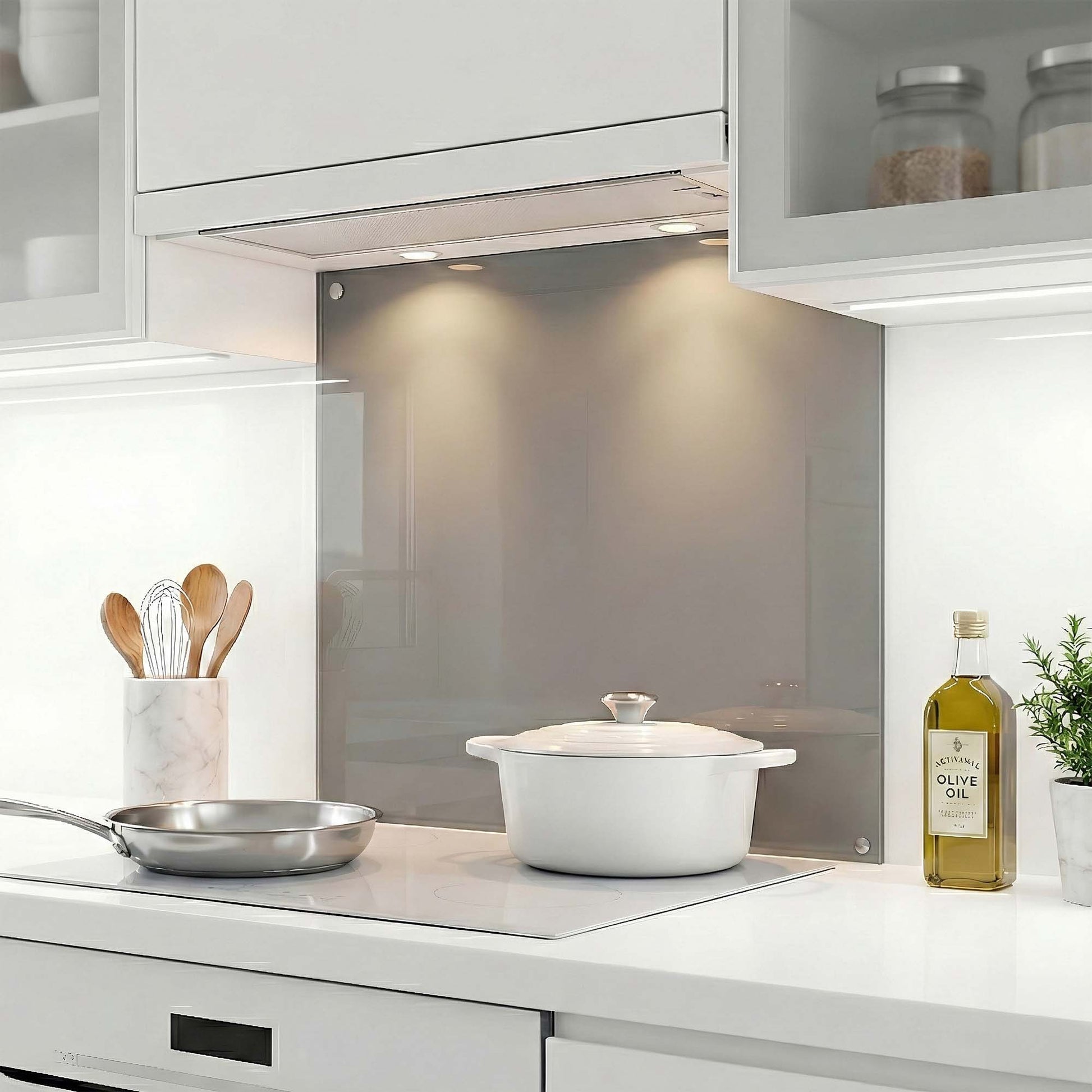 Modern kitchen with white cabinets, glass splashback, and kitchen utensils.