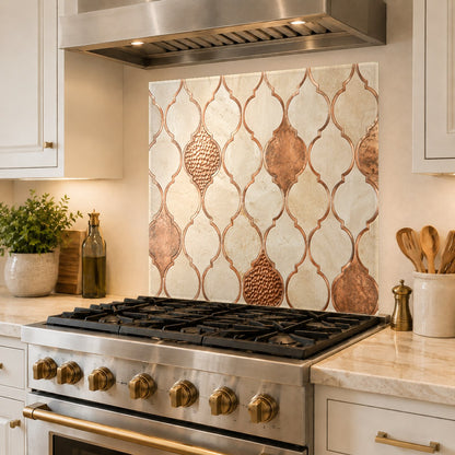 High-gloss copper geometric glass panel installed as a full backsplash behind a modern kitchen sink.