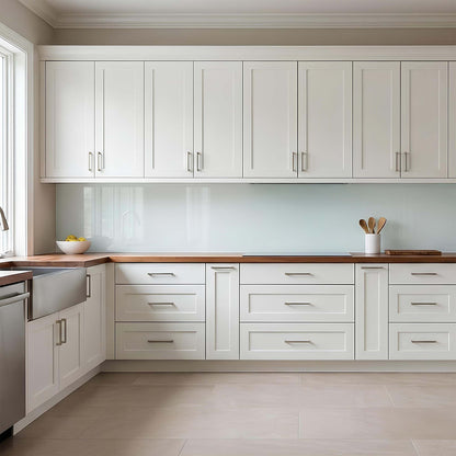 Modern kitchen with white cabinets, wooden countertops, and stainless steel appliances.