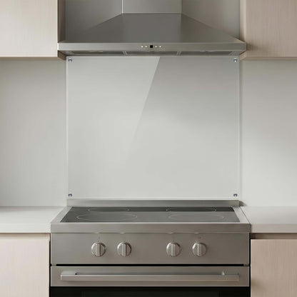 Stainless steel kitchen stove with glass splashback in a modern kitchen setting