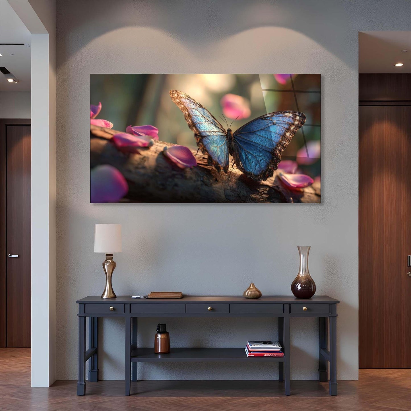Framed artwork of a blue butterfly on pink petals above a dark wooden console table.