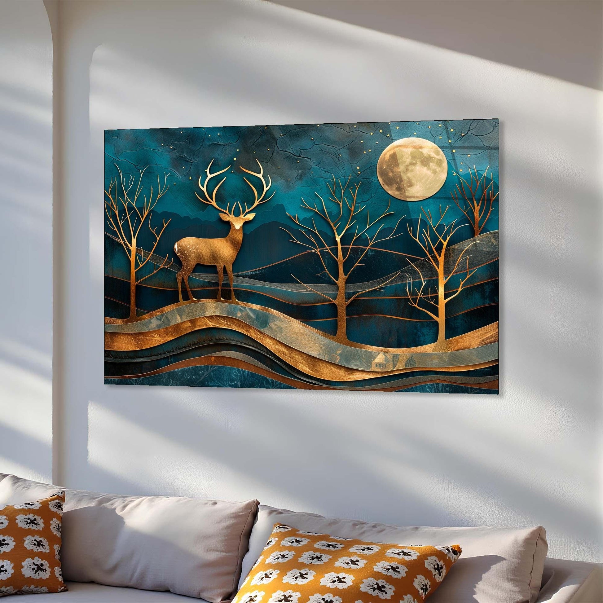 Decorative wall art with a deer and moon design on a white wall above a sofa.