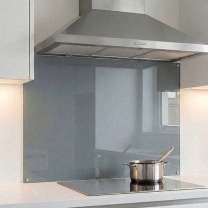 Modern kitchen with stainless steel range hood and glass splashback