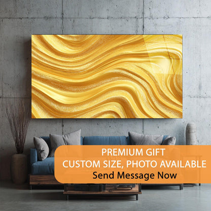 Abstract gold painting on a gray wall above a blue sofa with decorative pillows.