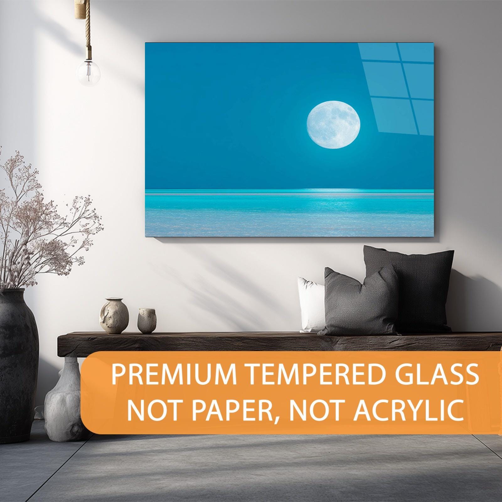 Modern living room with a large wall art piece of a blue sky and moon, text overlay about premium tempered glass.