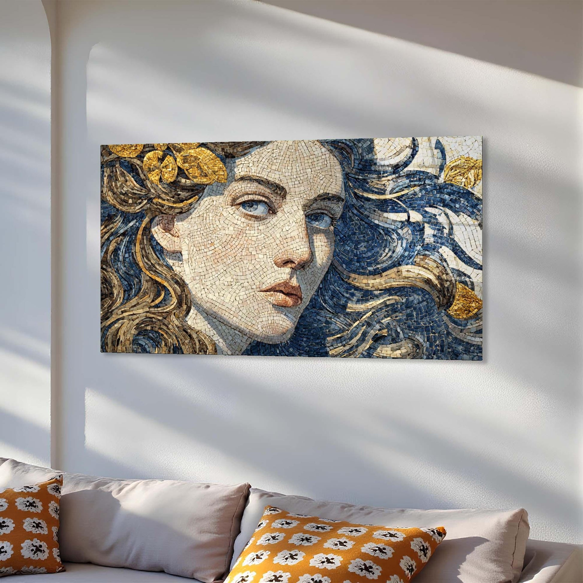 Mosaic artwork of a woman's face on a wall above a sofa with decorative pillows.
