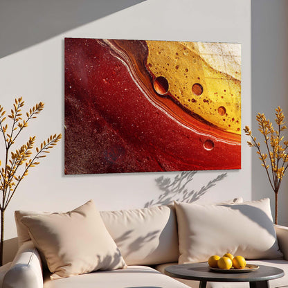 Abstract art piece on a wall above a sofa with decorative elements.