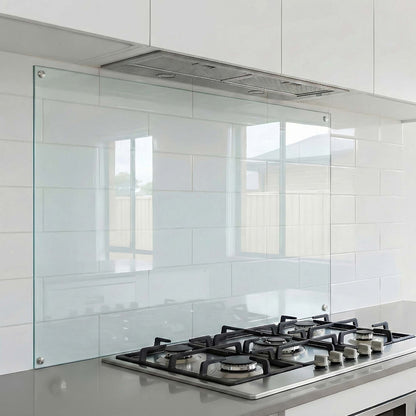 Modern kitchen with gas stove and clear glass backsplash