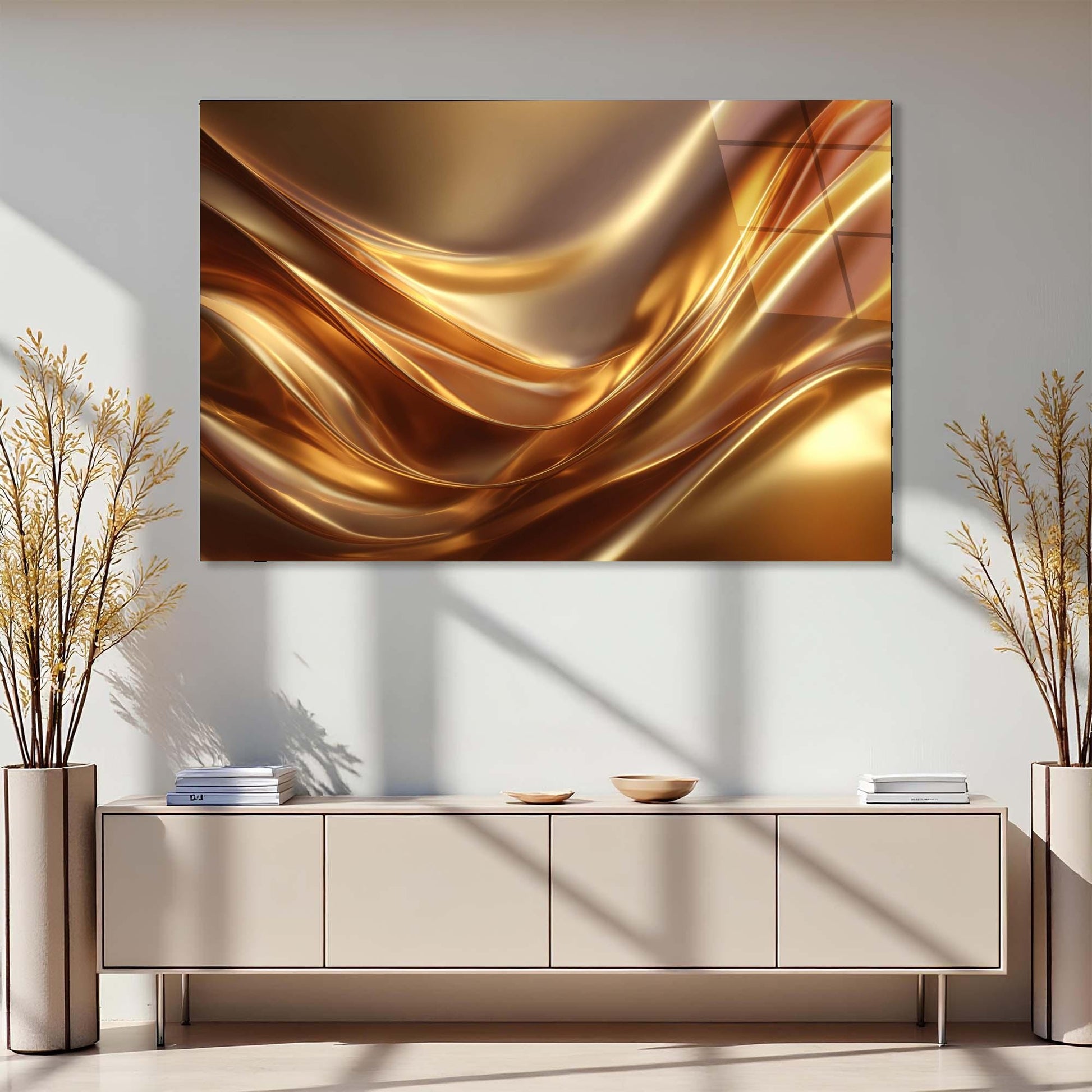 Abstract gold painting on a wall above a light-colored cabinet with decorative plants on either side.