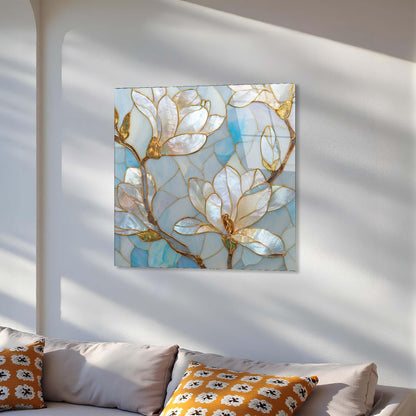 Decorative floral painting on a wall above a sofa with patterned cushions.