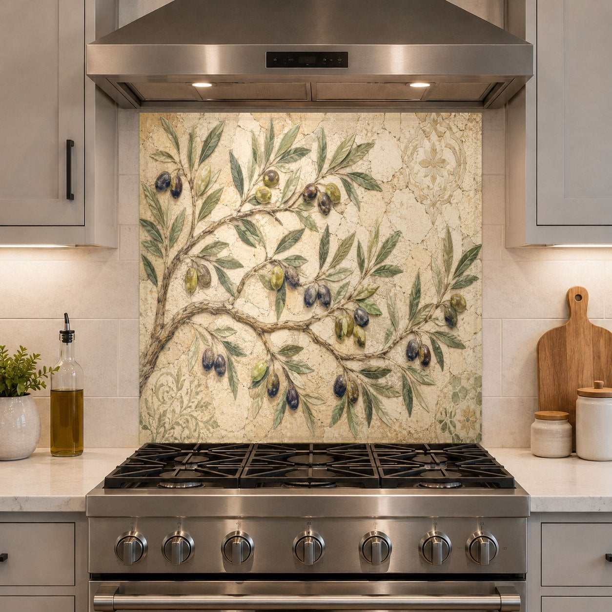 Earthy green kitchen glass backsplash with olive branches behind a slide-in range