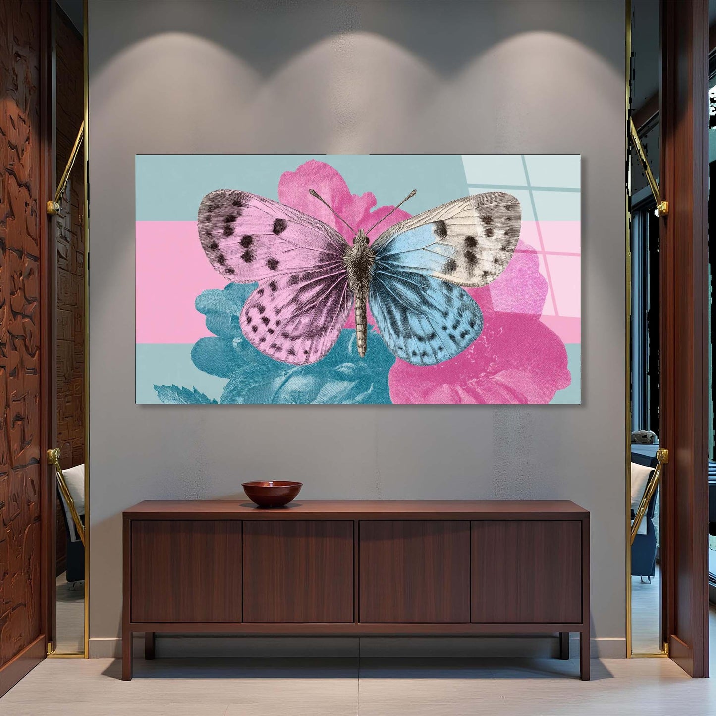 Framed artwork of butterflies on flowers above a wooden cabinet.