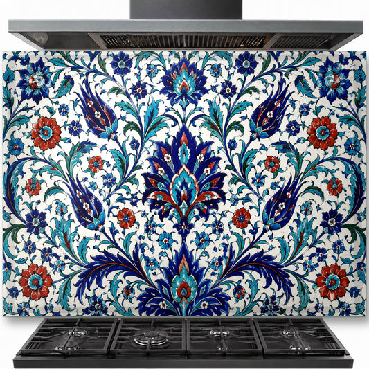 Traditional blue and white Iznik tile pattern on a tempered glass backsplash installed behind a modern gas stove.